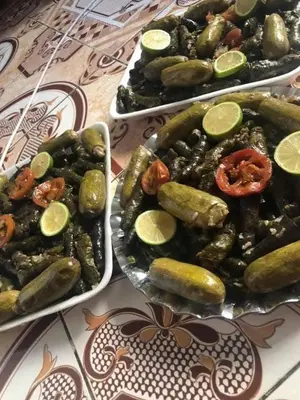 three trays of pickles and cucumbers on a table at Board apartment in Irbid