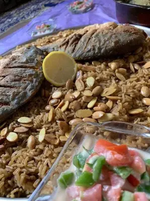 a tray of food with peanuts and fish and bread at Board apartment in Irbid