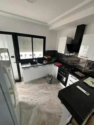 a kitchen with a stove and a counter top at Board apartment in Irbid