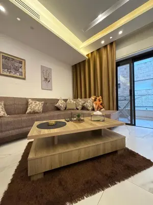 a living room with a couch and a table at 3bedroom apart Deir Ghbar JRE in Amman