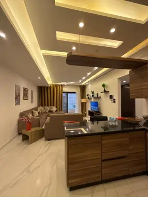 a living room with a couch and a table at 3bedroom apart Deir Ghbar JRE in Amman