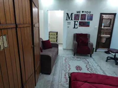a living room with a couch and a chair at Nice comfy room in Amman