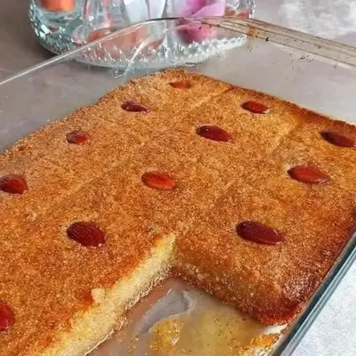 a close up of a cake in a glass pan at Rawabi INN in Maţār al Malik Ḩusayn