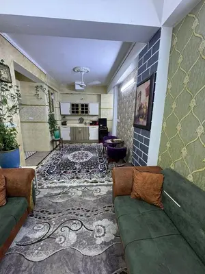 a living room with a couch and a rug at Rawabi INN in Maţār al Malik Ḩusayn