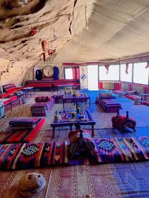 a large room with couches and tables in a tent at Rose Al Ghaith Camp in Disah