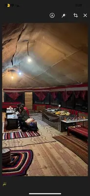 a room with tables and chairs in a tent at Rose Al Ghaith Camp in Disah