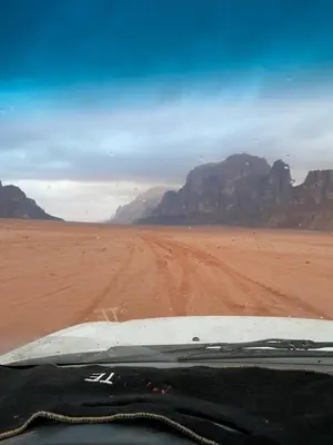 a view of a dirt road in the desert at The heartbeat of the desert and the stars in Wadi Rum