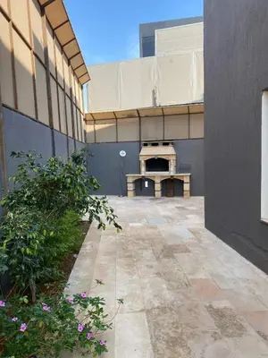 an outside view of a building with a patio at SAN VITO Chalet in Sowayma