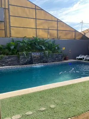 a swimming pool on the side of a building at SAN VITO Chalet in Sowayma