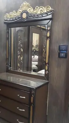 a mirror on top of a dresser in a room at Coazmatic apartment in Kerak