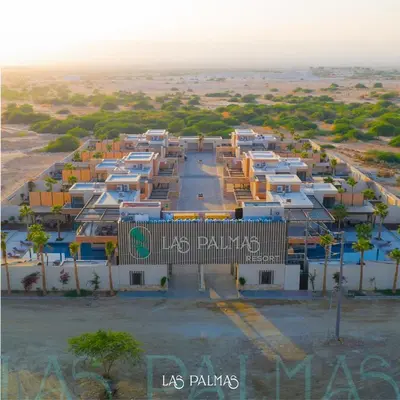 an aerial view of a parking lot in a desert at Las palmas resort in Sowayma