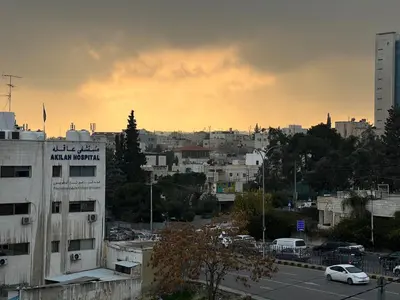a view of a city with a building and cars at Amman Antique Penthouse in Amman