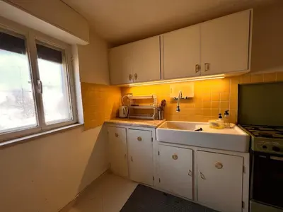 a small kitchen with a sink and a microwave at Amman Antique Penthouse in Amman