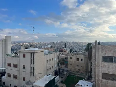 a view of a city from the top of a building at Amman Antique Penthouse in Amman
