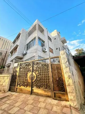 a house with a large golden gate in front of it at Amman Antique Penthouse in Amman
