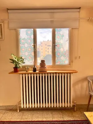 a window with a radiator in a room at Amman Antique Penthouse in Amman