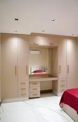 a bedroom with white cabinets and a red bed at Halimah 3BR Luxury Apt-Der Ghbar in Amman