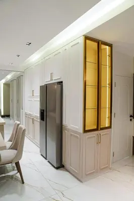a kitchen with white cabinets and a refrigerator at Halimah 3BR Luxury Apt-Der Ghbar in Amman
