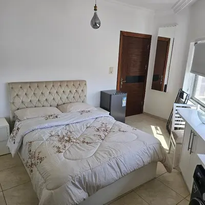 a bedroom with a large bed in a room at Cozy apartment in Amman