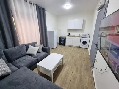 a living room with a couch and a table at Sama Dier Ghbar 1 in Amman