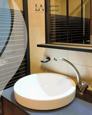 a bathroom with a white sink and a mirror at Al RAHA village - Aqaba أستوديو بقرية الراحه العقبة مرسى زايد in Aqaba