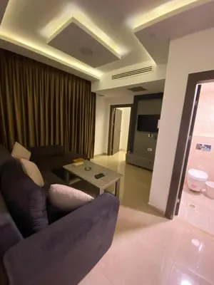 a living room with a couch and a table at abdoun rooftop 1bedroom kh&sh 04 in Amman