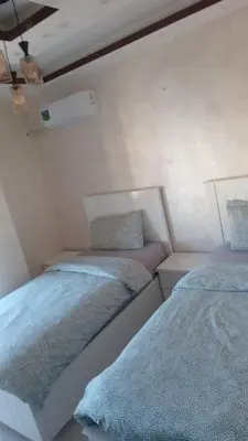 a room with two beds in a room at Sawa Apartment in Amman
