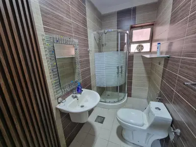 a bathroom with a toilet and a sink and a shower at Sama Dier Ghbar 3 in Amman