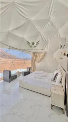 a bedroom with a large bed in a tent at RUM CITY STAR BUBBLE lUXURY CAMP in Wadi Rum