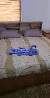 a pair of blue umbrellas laying on a bed at zragat hotel in Jerash