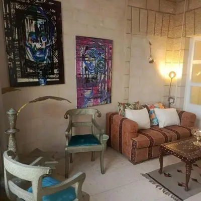 a living room with a couch and a chair at Lukanda Apartment Feel at Home in Amman