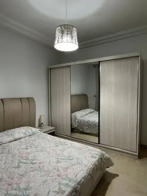 a bedroom with a bed and a large mirror at carfort House in Al Jafr