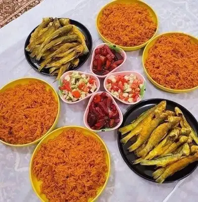 a table with plates of food and bowls of food at carfort House in Al Jafr