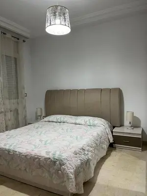 a bedroom with a large bed with a large headboard at carfort House in Al Jafr
