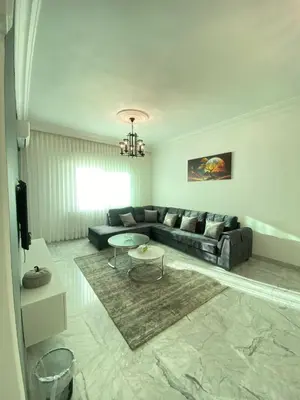 a living room with a couch and a table at Layal's apartment in Amman