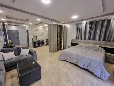 a large bedroom with a bed and a couch at Sama Dier Ghbar 5 in Amman
