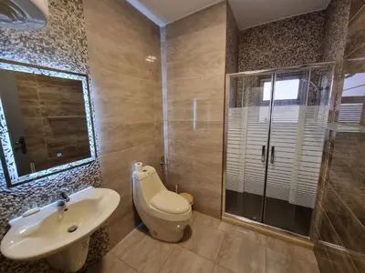 a bathroom with a toilet and a sink and a shower at Sama Dier Ghbar 5 in Amman