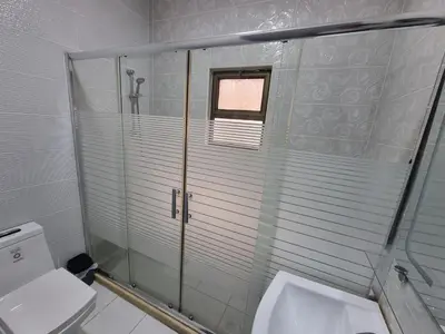a bathroom with a shower and a toilet at Sama Dier Ghbar 6 in Amman