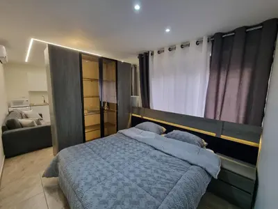 a bedroom with a large bed and a couch at Sama Dier Ghbar 6 in Amman