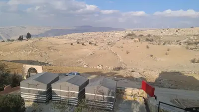 a view of a building in the middle of a desert at Dana local Life Eco lodge in At-Tafilah