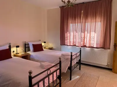 a bedroom with two beds and a window at Baytna Hotel in Petra