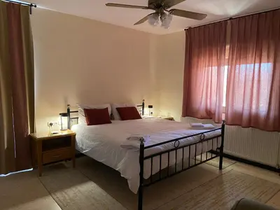 a bedroom with a bed and a ceiling fan at Baytna Hotel in Petra