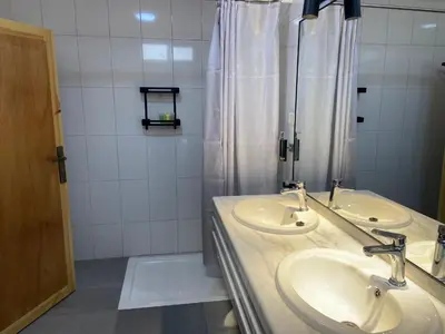 a bathroom with two sinks and a shower at Baytna Hotel in Petra