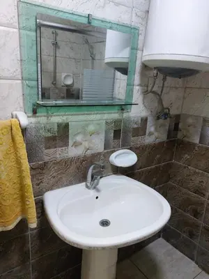 a bathroom with a white sink and a mirror at Casa la Serena in Madaba