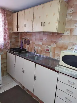 a small kitchen with a sink and a microwave at Casa la Serena in Madaba