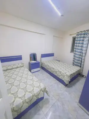 a bedroom with two beds in a room at المنشيه ان in Al Manshīyah