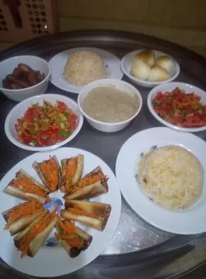 a tray of food with plates of food on a table at المنشيه ان in Al Manshīyah