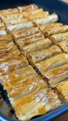 a tray filled with glazed squares of food at المنشيه ان in Al Manshīyah