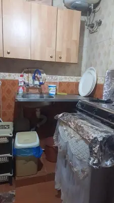 a kitchen with a counter and a sink and a toilet at الدونق in Amman
