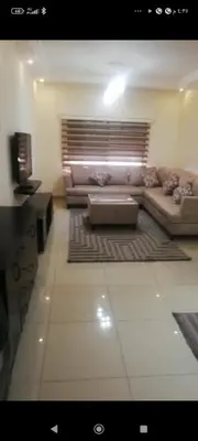 a living room with a couch and a table at شقه رقم 14 خلف كوزمو in Amman
